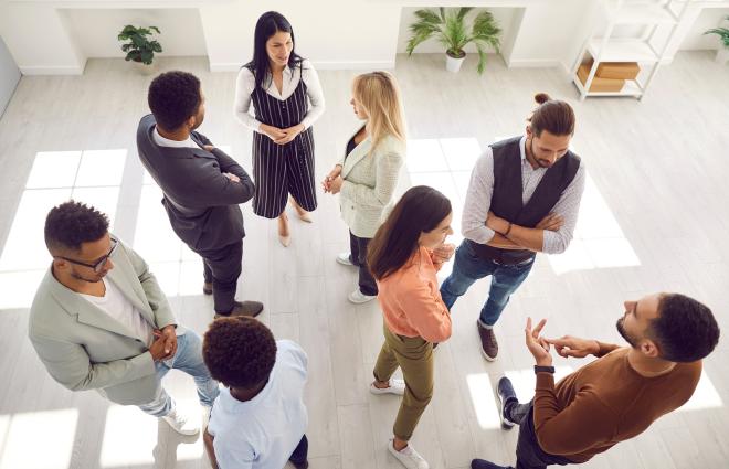 People standing and networking (Studio Romantic / Adobe Stock)